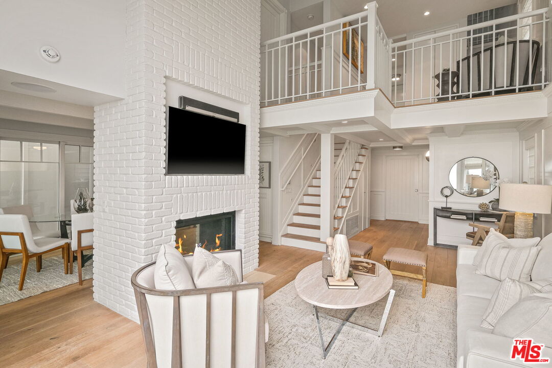 19236 Pacific Coast Highway Malibu, CA 90265 - Photo 15 of 41 a living room with furniture a fireplace and a flat screen tv