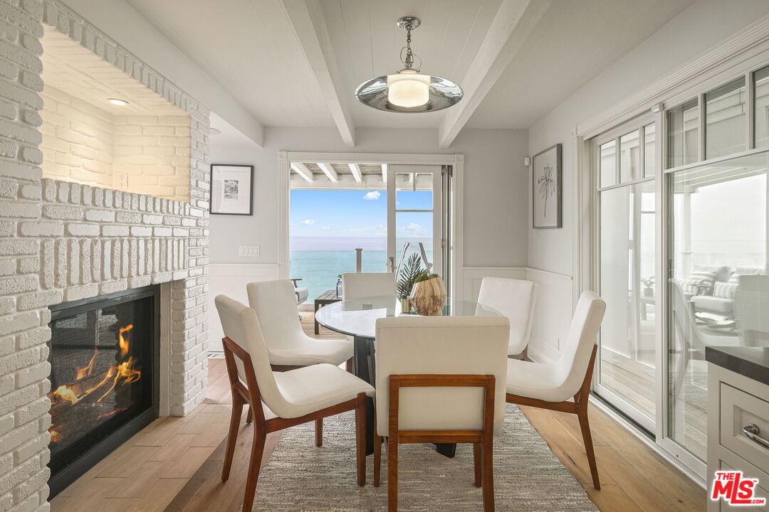 19236 Pacific Coast Highway Malibu, CA 90265 - Photo 17 of 41 a view of a dining room with furniture window and wooden floor