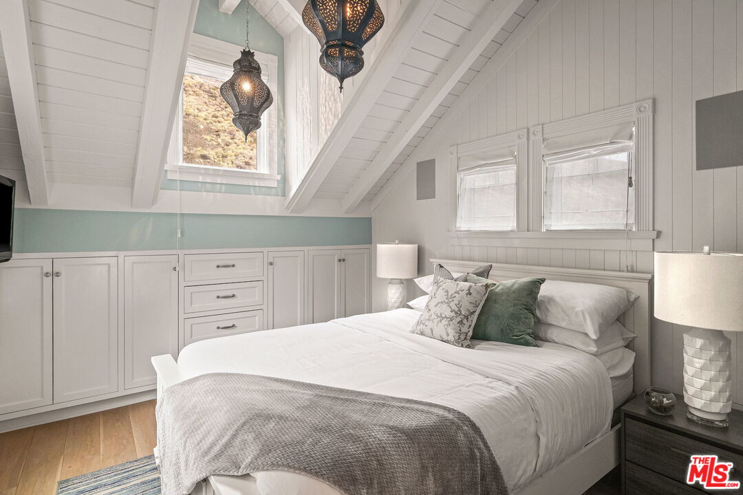 19236 Pacific Coast Highway Malibu, CA 90265 - Photo 25 of 41 a bedroom with a bed and a night stand