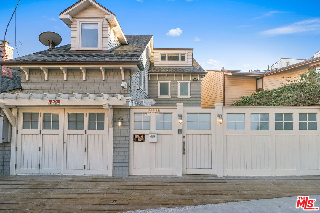 19236 Pacific Coast Highway Malibu, CA 90265 - Photo 4 of 41 a front view of a house with a yard