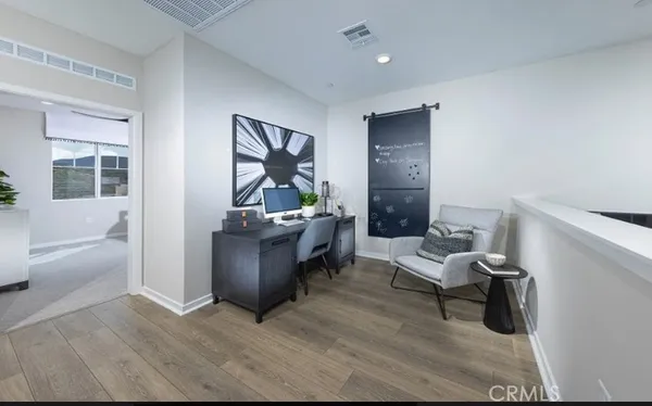 a living room with furniture and a painting on the wall