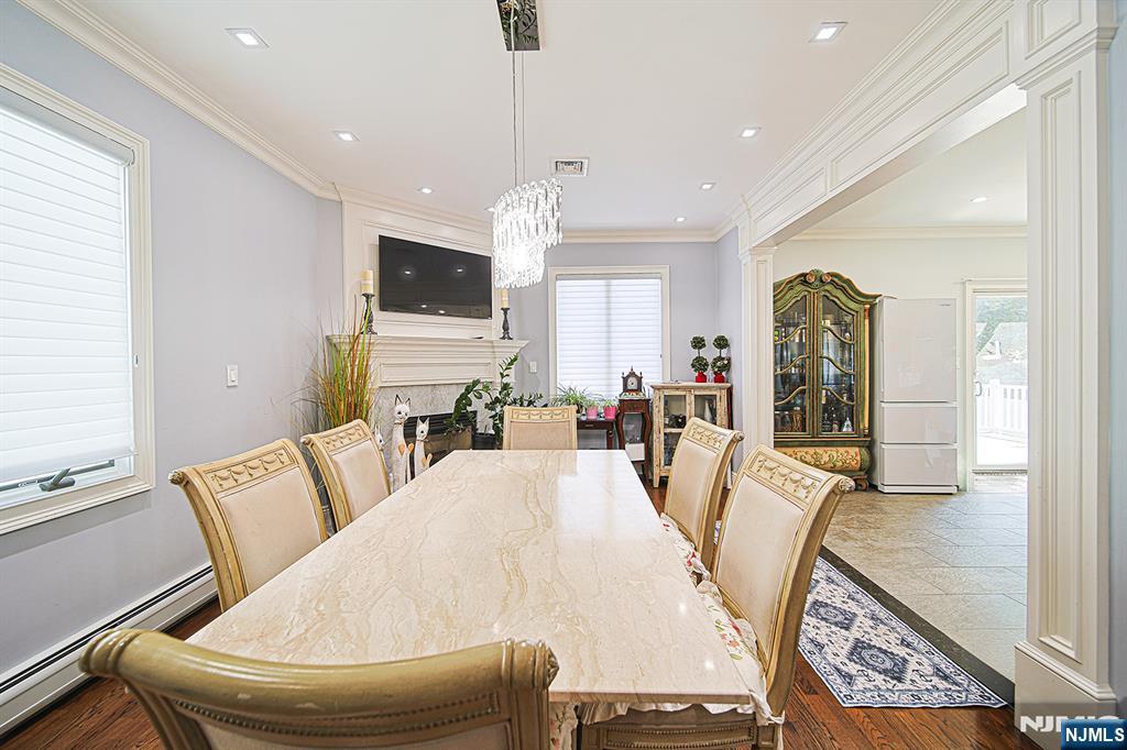 897 Virgil Avenue Ridgefield, NJ 07657 - Photo 22 of 50 a living room with furniture a flat screen tv and kitchen view
