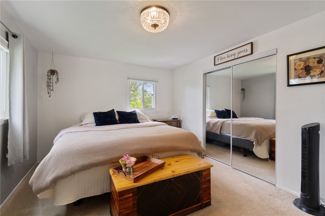 218 Kusak Road Henrietta, NY 14467 - Photo 10 of 33 Primary bedroom with mirrored closet doors.