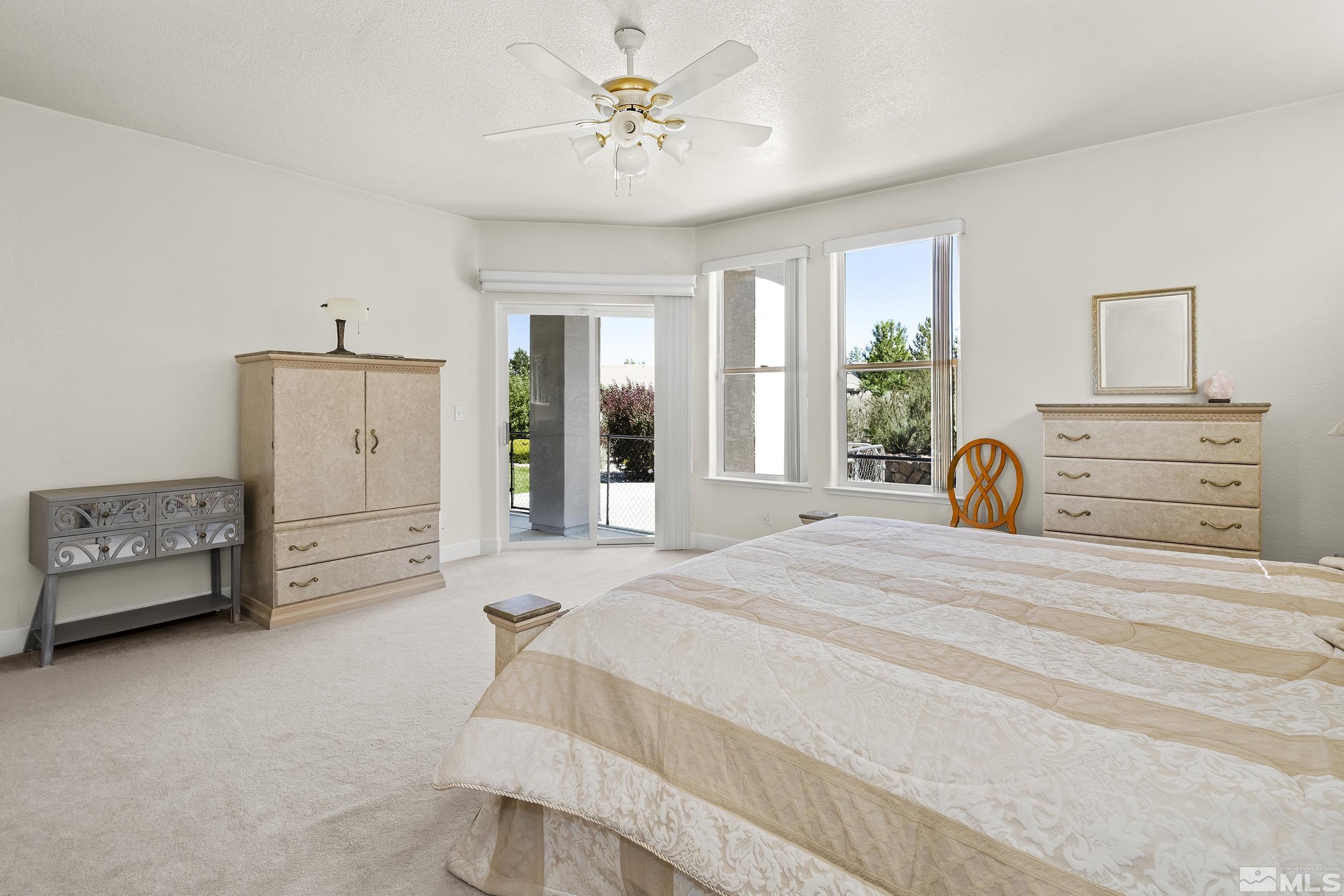 1540 Star Way Reno, NV 89511 - Photo 26 of 37 a bedroom with a bed and a chandelier