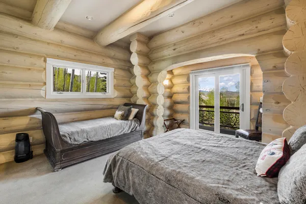 a bedroom with a bed and a chandelier