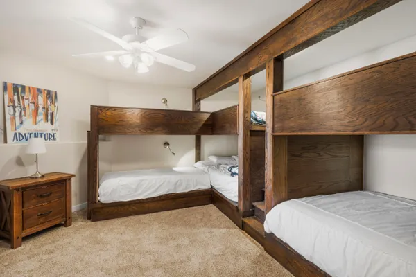 a bedroom with a large bed and a refrigerator