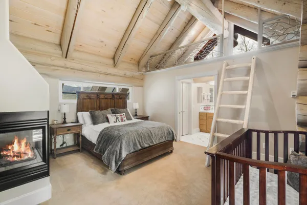 a spacious bedroom with a bed and a window