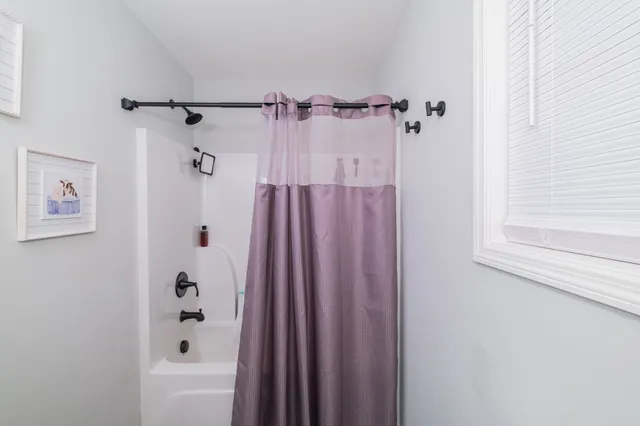 a bathroom with a shower and a bathtub