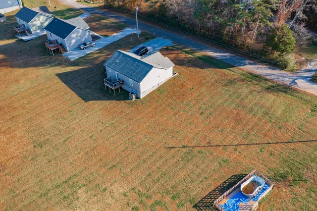 an aerial view of a house with a yard