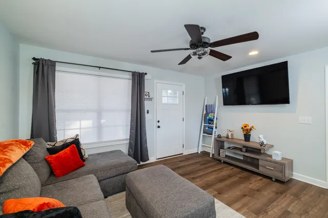 a bedroom with furniture and a flat screen tv