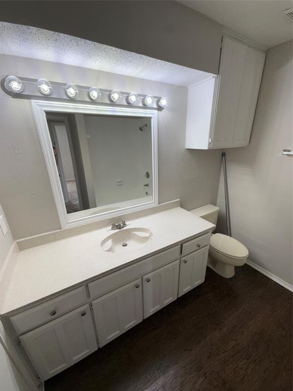 5908 Holiday Lane, Unit C North Richland Hills, TX 76180 - Photo 14 of 18 a bathroom with a sink a toilet and a mirror