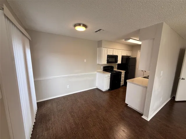 a view of kitchen with furniture and wooden floor