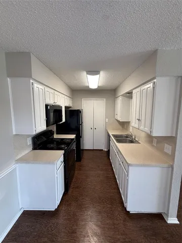 a large kitchen with a stove top oven