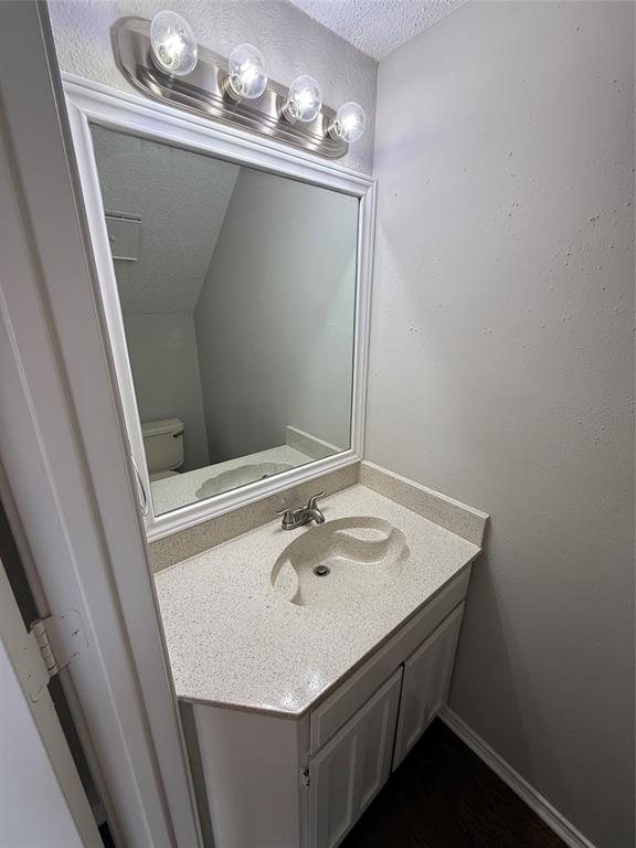 5908 Holiday Lane, Unit C North Richland Hills, TX 76180 - Photo 7 of 18 a bathroom with a sink and a mirror