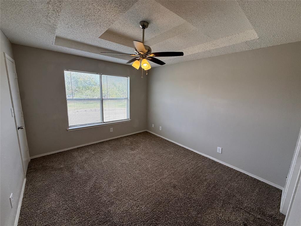 5908 Holiday Lane, Unit C North Richland Hills, TX 76180 - Photo 10 of 18 an empty room with windows and fan