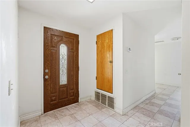 a view of a livingroom with wooden floor and a window