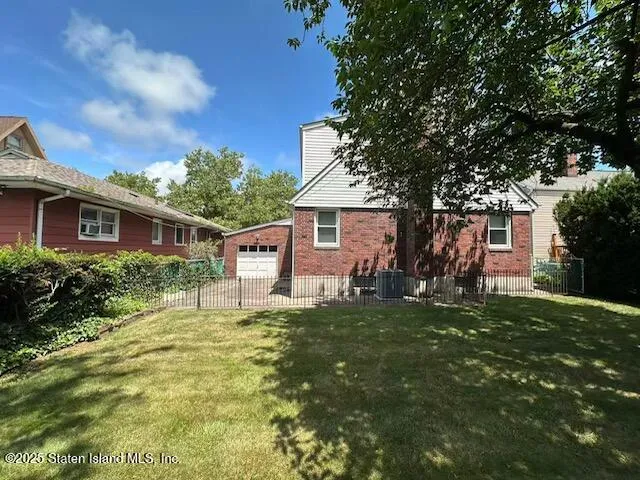 a house view with a sitting space and garden