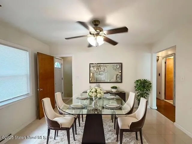 a view of a dining room with furniture and a chandelier