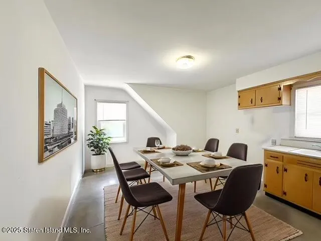 a view of a dining room with furniture and window