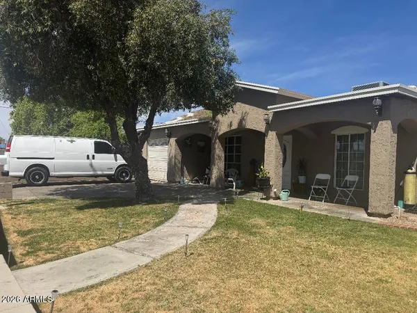 a view of a house with backyard porch and sitting area