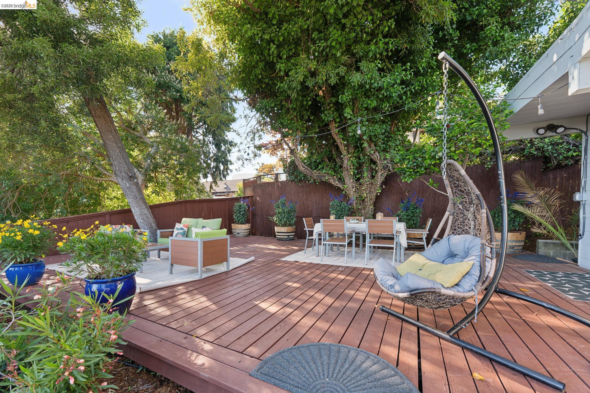2301 Oak Street Berkeley, CA 94708 - Photo 36 of 61 Expansive wood-finish deck with multiple distinct seating areas, surrounded by mature trees