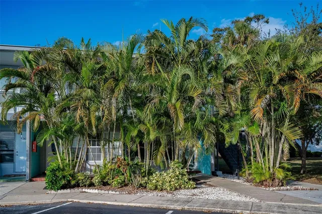 a view of a house with a yard and a garage