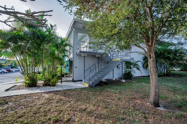 a view of a house with a tree and a yard
