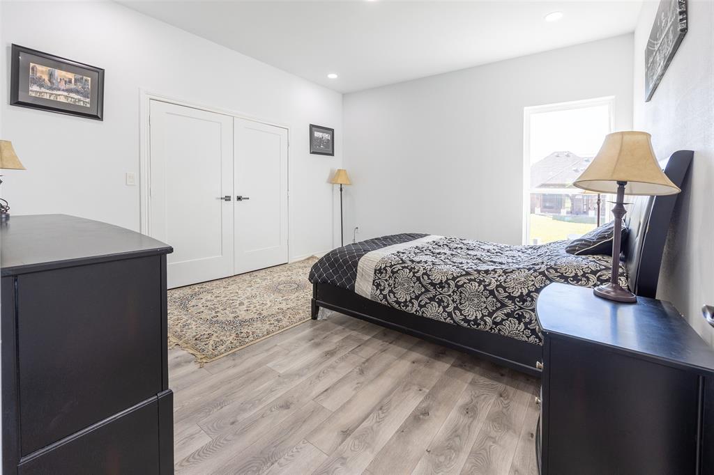 2630 Rockhill Road Aubrey, TX 76227 - Photo 32 of 36 a bedroom with a bed and a table