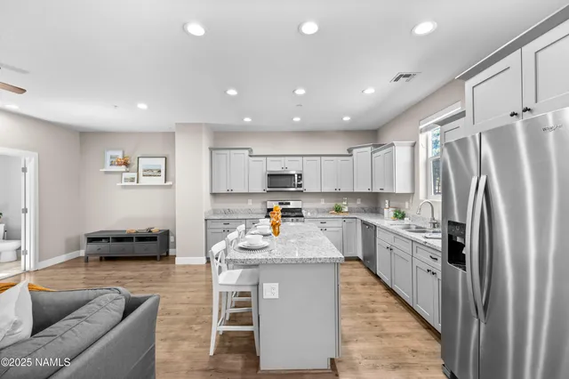 a kitchen with refrigerator cabinets and furniture