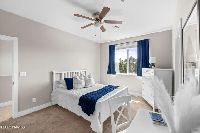 a bedroom with a large bed and a large window