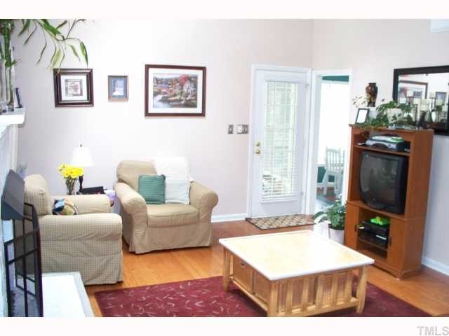 4412 Liverpool Lane Raleigh, NC 27604 - Photo 3 of 12 a living room with furniture and a flat screen tv