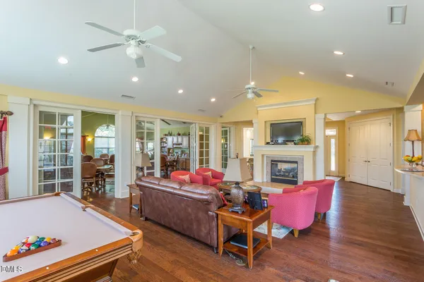 a living room with furniture fireplace and flat screen tv