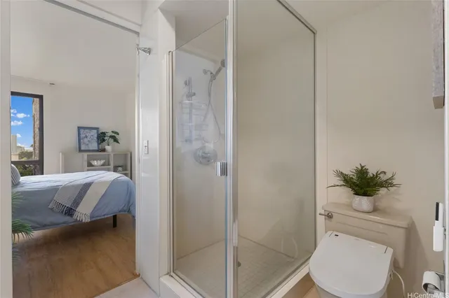 a bathroom with a granite countertop sink a toilet and shower