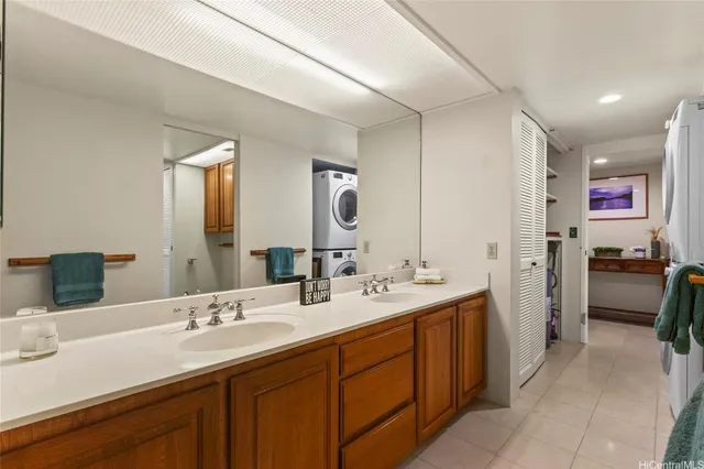 a spacious bathroom with a double vanity sink a mirror and a shower