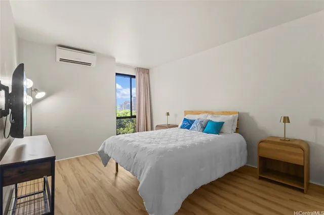 a bedroom with a bed and a wooden floor