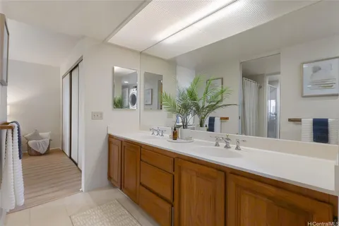 a spacious bathroom with a double vanity sink and a mirror