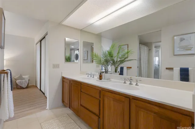 a spacious bathroom with a double vanity sink and a mirror