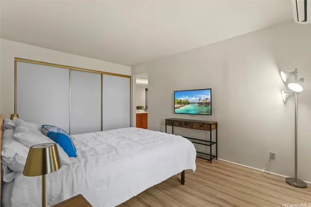 a bedroom with a bed and a painting on the wall