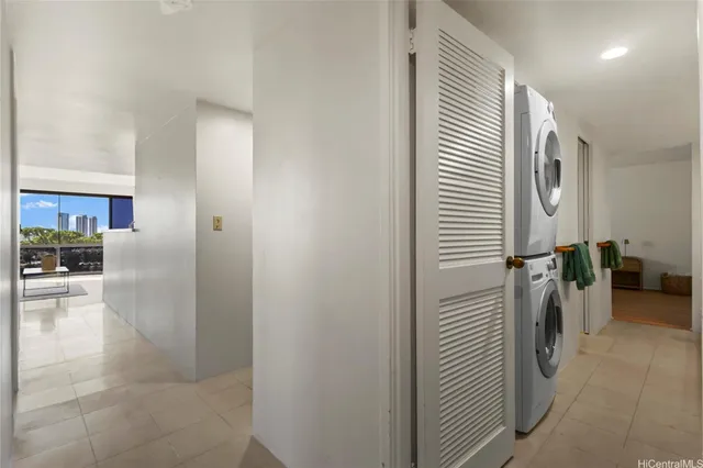 a view of a hallway with dining area and chandelier