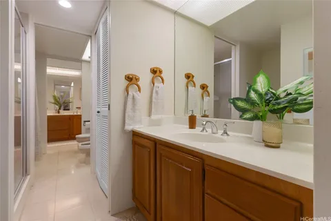 a bathroom with a granite countertop sink a large mirror and a shower