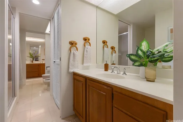 a bathroom with a granite countertop sink a large mirror and a shower