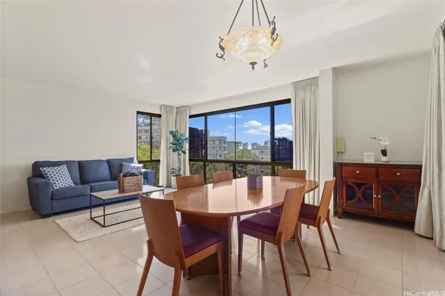 a dining room with furniture a chandelier and window
