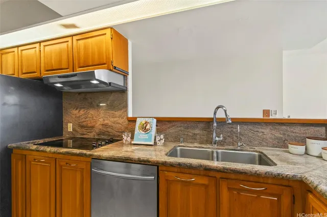 a kitchen with stainless steel appliances granite countertop a sink a stove and a microwave oven