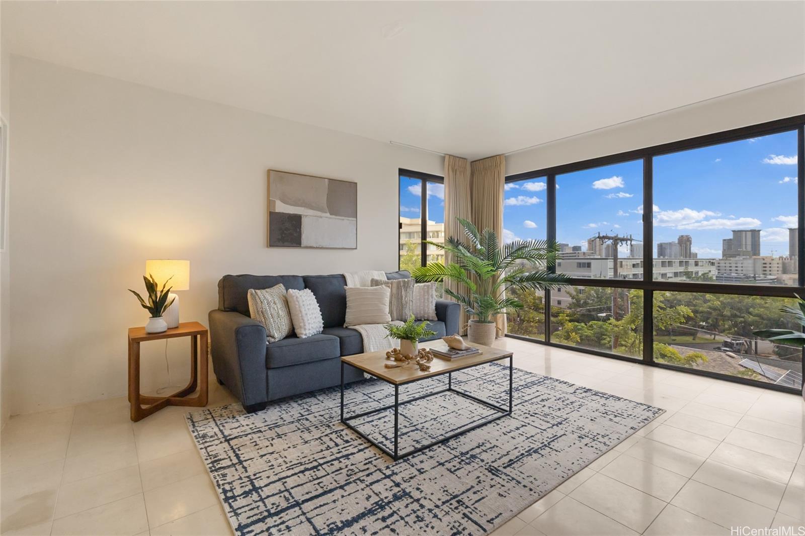 217 Prospect Street, Unit D11 Honolulu, HI 96813 - Photo 3 of 24 a living room with furniture and a floor to ceiling window
