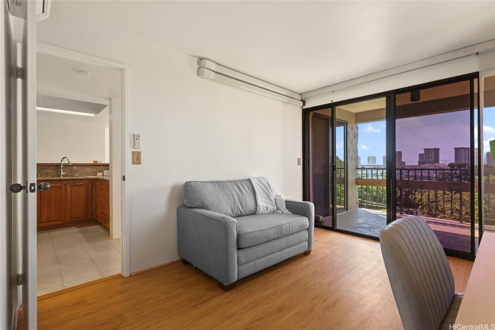 217 Prospect Street, Unit D11 Honolulu, HI 96813 - Photo 10 of 25 a living room with furniture and a floor to ceiling window