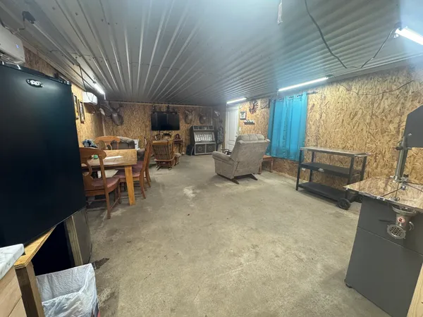 a living room with furniture a fireplace a rug potted plant and a large window