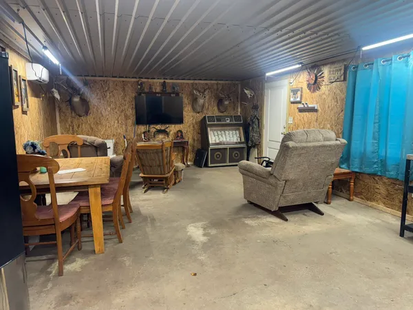 a living room with furniture a flat screen tv and a large window