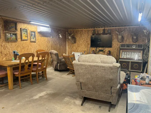 a living room with furniture a flat screen tv and kitchen view