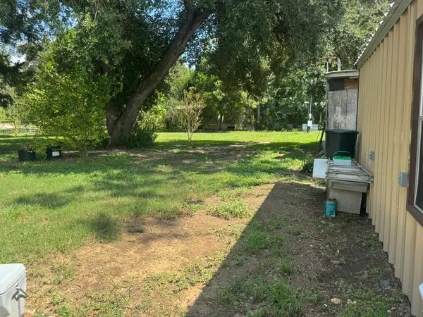 a view of a backyard with a sitting area