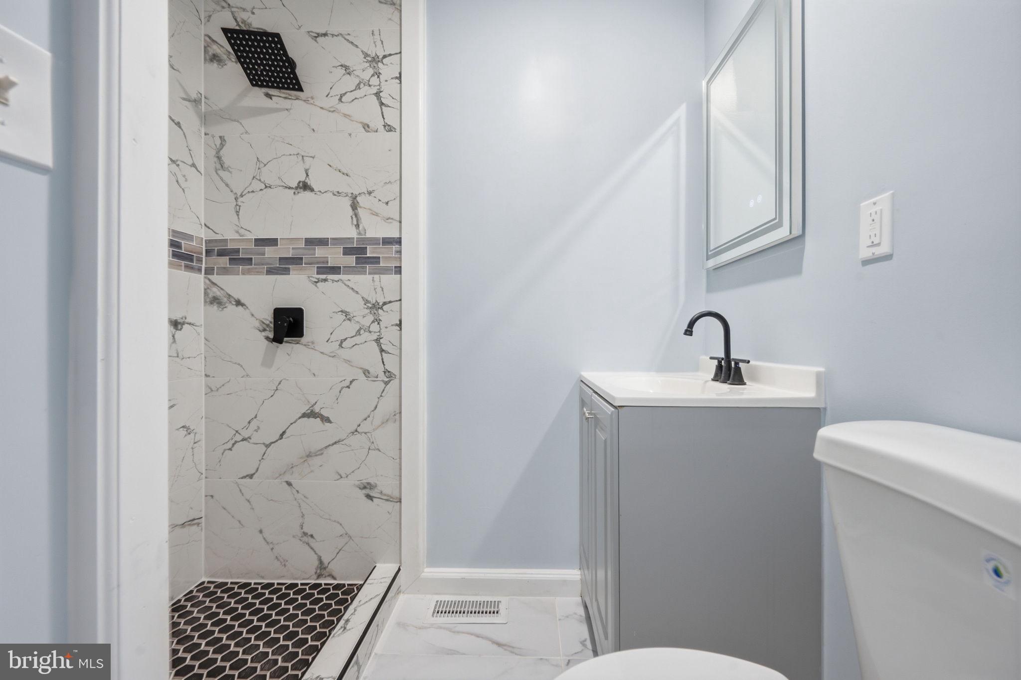 517 Valcour Road Baltimore, MD 21228 - Photo 2 of 47 a bathroom with a sink and a toilet